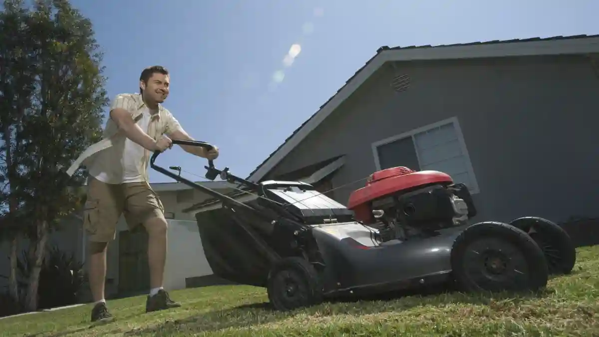 man using lawn mower
